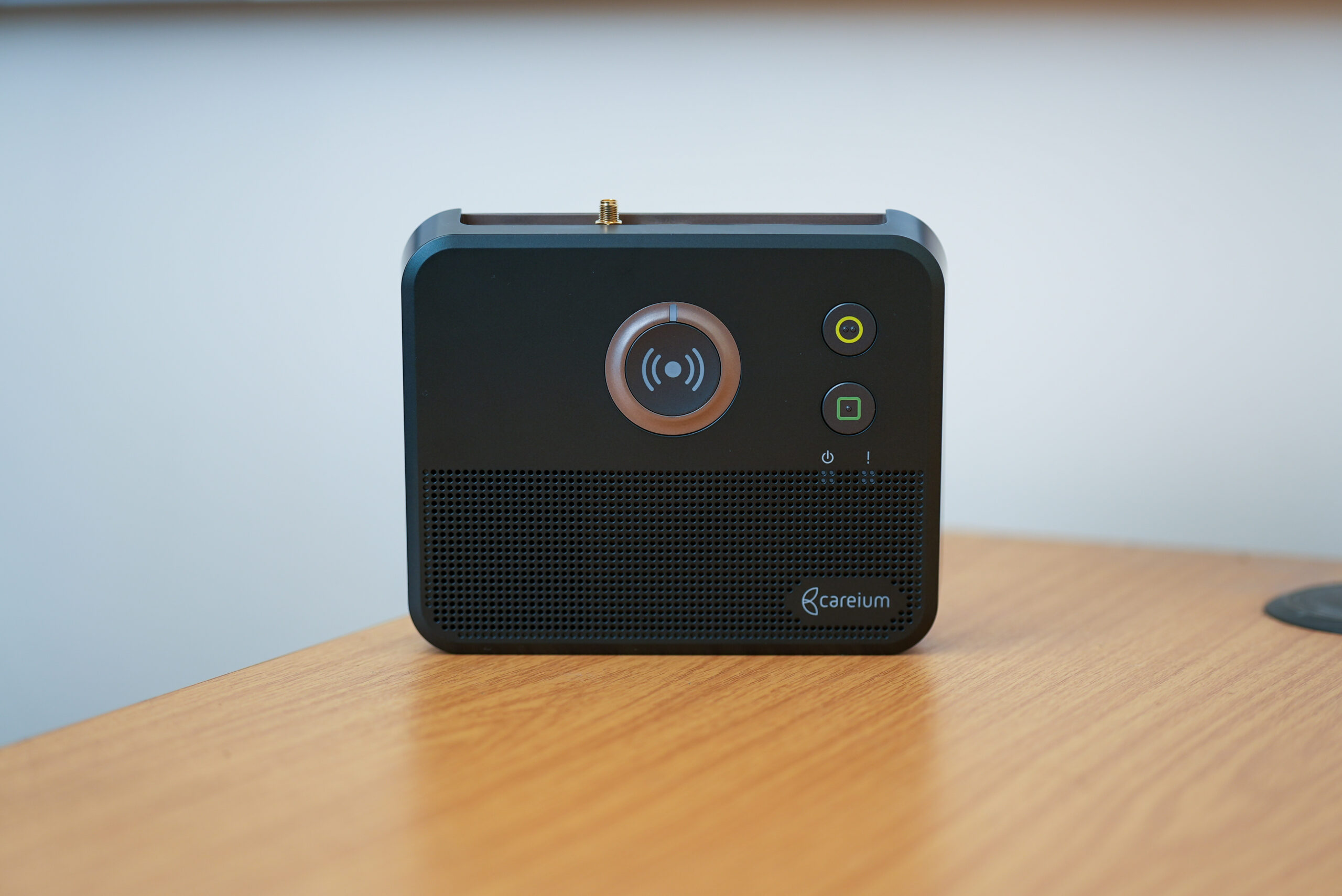 Careium telecare base unit with central alert button, indicator lights and speaker.